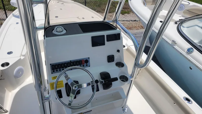 Slide: The Image of 2024 Key West 210 Bay Reef boat console with steering wheel and controls. - 7