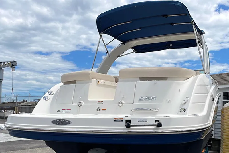 Slide: The Image of 2007 Chaparral 256 SSi boat with blue canopy and white seating. - 1