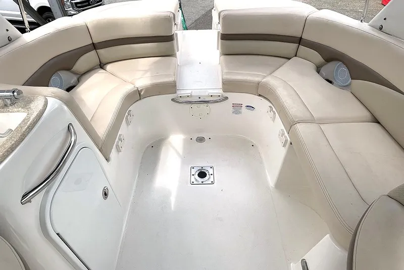 Slide: The Image of 2007 Chaparral 256 SSi boat interior with beige seating and storage compartments. - 3