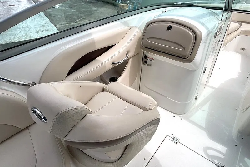 Slide: The Image of 2007 Chaparral 256 SSi boat interior with beige seating and storage compartment. - 4