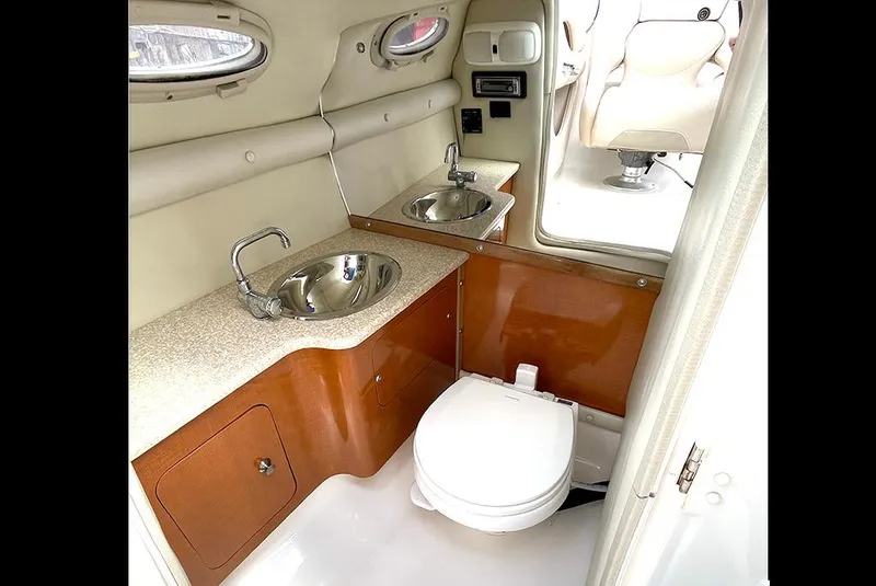 Slide: The Image of 2007 Chaparral 256 SSi boat bathroom with dual sinks and toilet. - 8