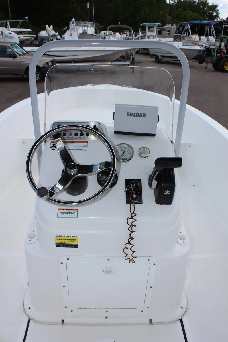 Slide: The Image of 2024 Clearwater 1900 boat console with steering wheel and Simrad navigation system. - 17