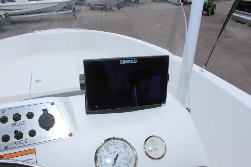 Slide: The Image of Clearwater 1900 2024 boat dashboard with Simrad display and gauges. - 18