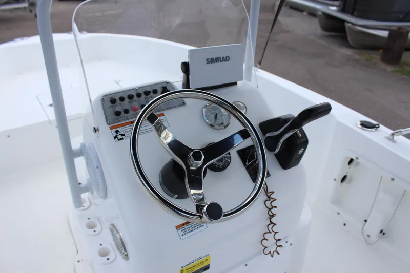 Slide: The Image of Clearwater 1900 2024 boat console with steering wheel and Simrad navigation system. - 19