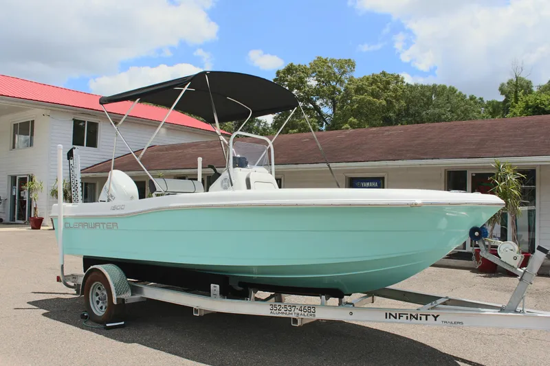 Slide: The Image of 2024 Clearwater 1900 boat on trailer with bimini top, parked outside dealership. - 3