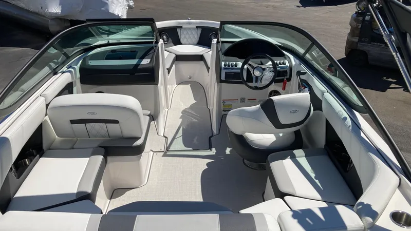 Slide: The Image of 2024 Regal 2000 ES boat interior with white and gray seating. - 2