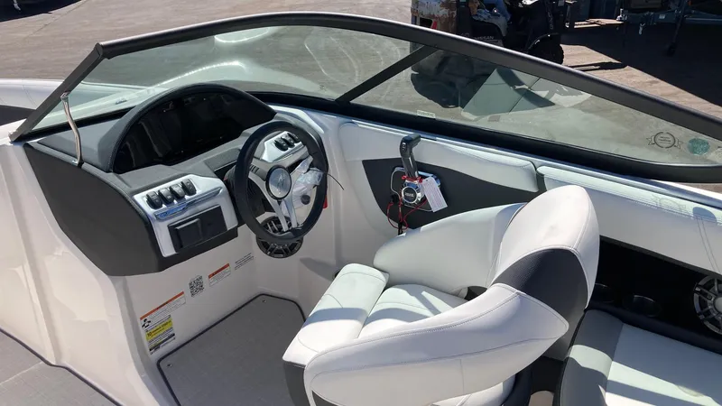 Slide: The Image of 2024 Regal 2000 ES boat interior with steering wheel and white seating. - 5