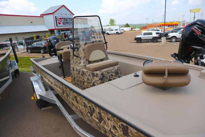 Slide: The Image of 2024 Excel 1860 Stalker CC boat in parking lot near Tractor Supply store. - 0