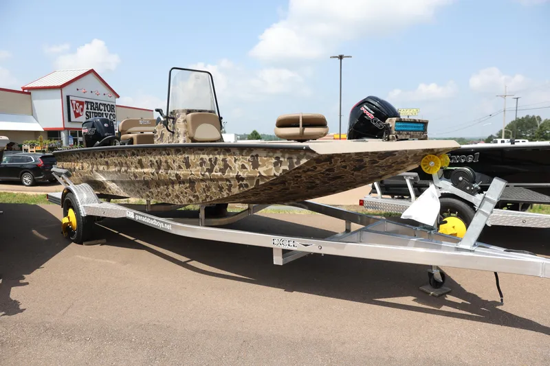 Slide: The Image of 2024 Excel 1860 Stalker CC boat on trailer outside Tractor Supply store. - 1