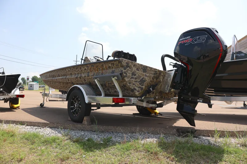 Slide: The Image of 2024 Excel 1860 Stalker CC boat on trailer with outboard motor. - 2
