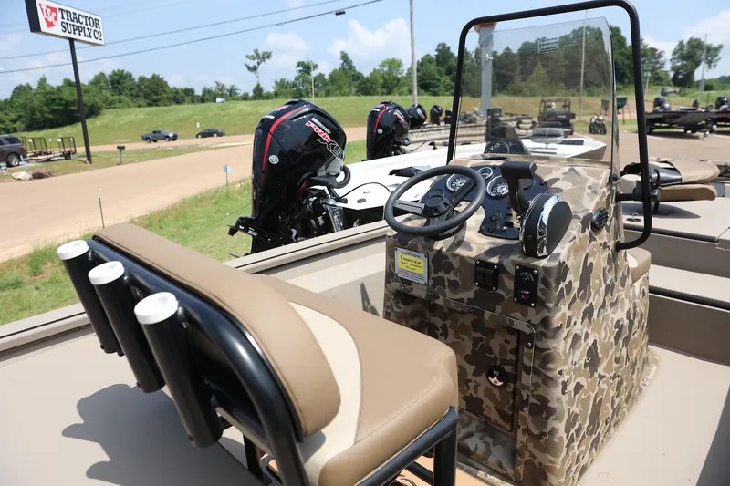 Slide: The Image of 2024 Excel 1860 Stalker CC boat with camo console and dual outboard motors. - 3