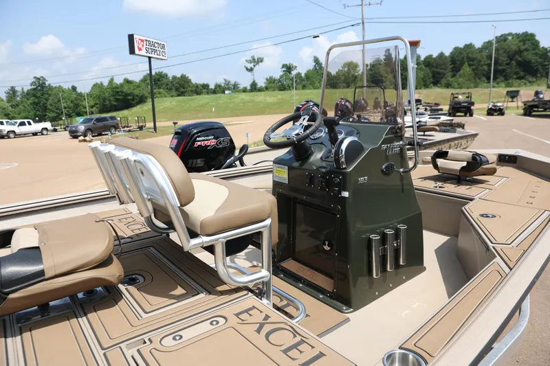 Slide: The Image of 2024 Excel 183 Bay Pro Elite boat interior with steering console and seating. - 2