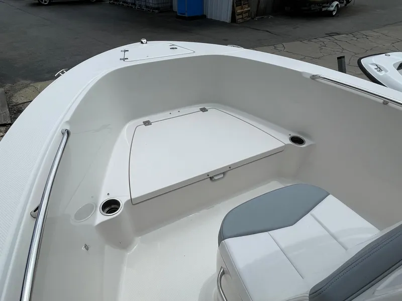 Slide: The Image of 2021 Robalo R180 Center Console boat interior with seating and storage. - 12