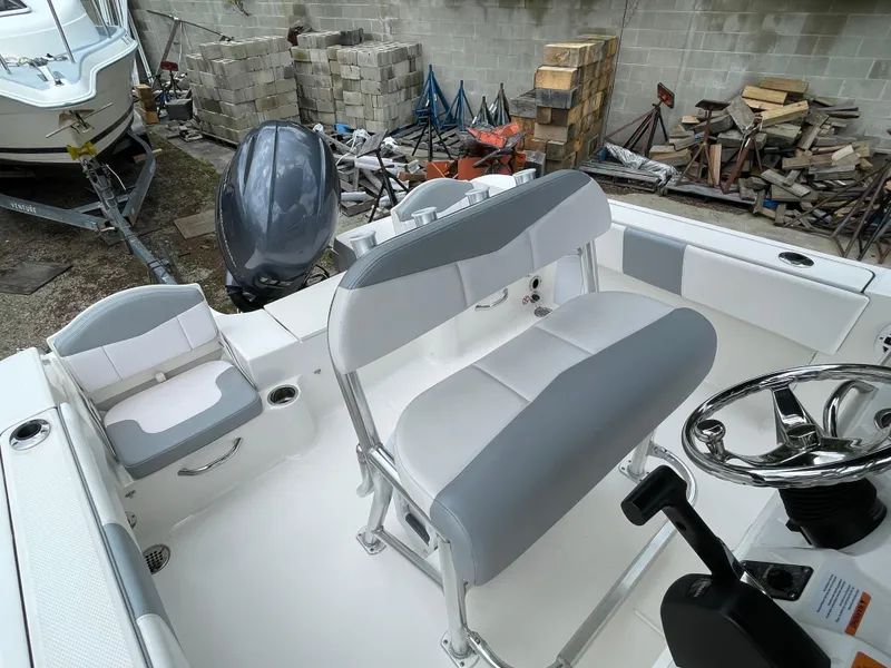 Slide: The Image of 2021 Robalo R180 Center Console boat interior with seating and steering wheel. - 13