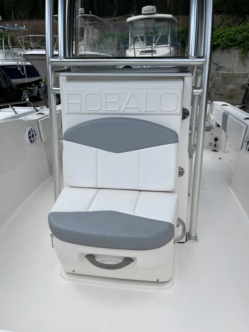 Slide: The Image of 2021 Robalo R180 Center Console boat with cushioned seating and sleek design. - 15