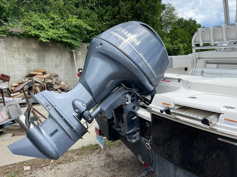 Slide: The Image of 2021 Robalo R180 Center Console with Yamaha outboard motor in a yard setting. - 18