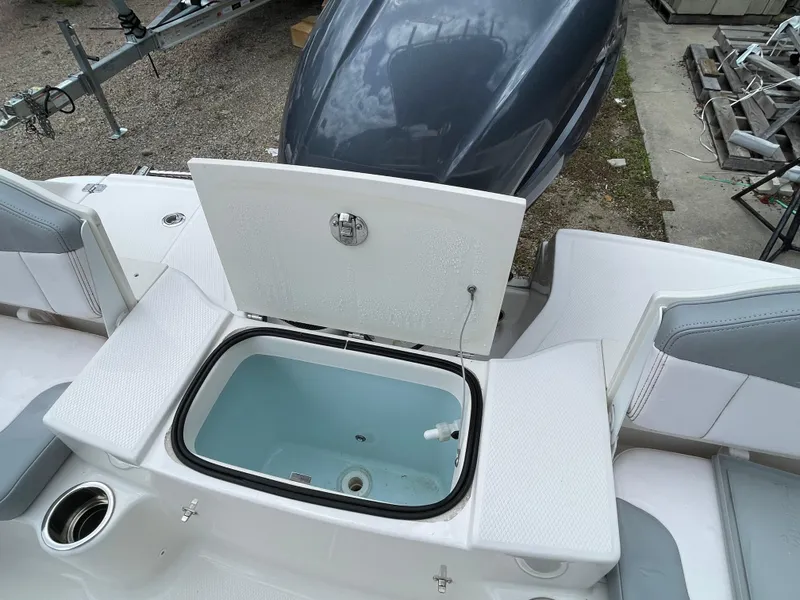 Slide: The Image of 2021 Robalo R180 Center Console boat with open storage compartment and seating. - 23