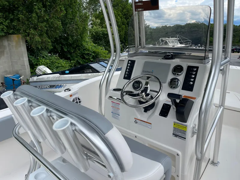 Slide: The Image of 2021 Robalo R180 Center Console boat interior with steering wheel and control panel. - 25