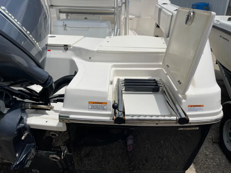 Slide: The Image of 2021 Robalo R180 Center Console boat with engine and swim platform. - 29