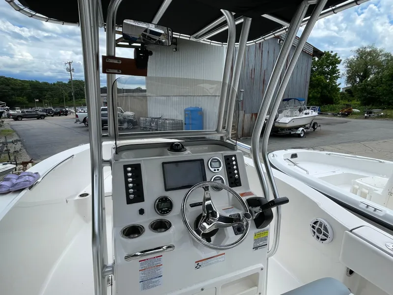 Slide: The Image of 2021 Robalo R180 Center Console boat interior with steering wheel and control panel. - 8