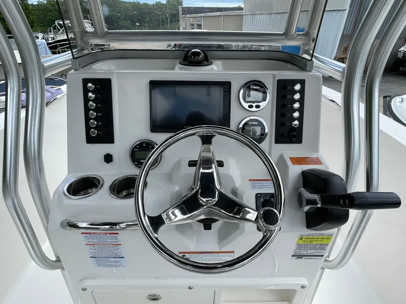 Slide: The Image of 2021 Robalo R180 Center Console dashboard with steering wheel and navigation controls. - 9