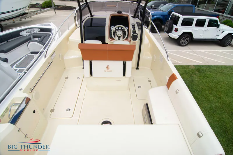 Slide: The Image of 2024 Capoforte CX280i boat interior with helm, seating, and storage compartments at Big Thunder Marine. - 13