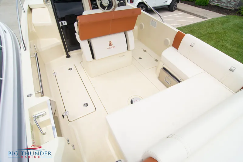 Slide: The Image of 2024 Capoforte CX280i boat interior with beige and brown seating, showcased by Big Thunder Marine. - 16
