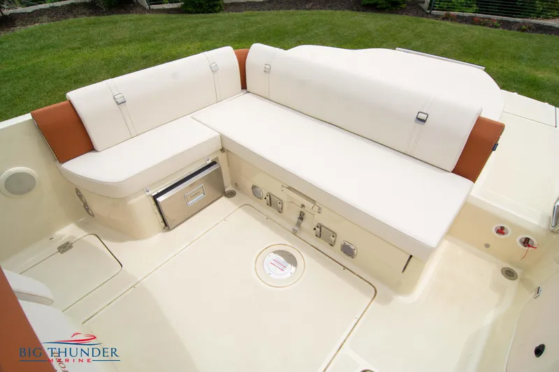 Slide: The Image of Capoforte CX280i 2024 boat interior with beige seating and storage compartments. - 17