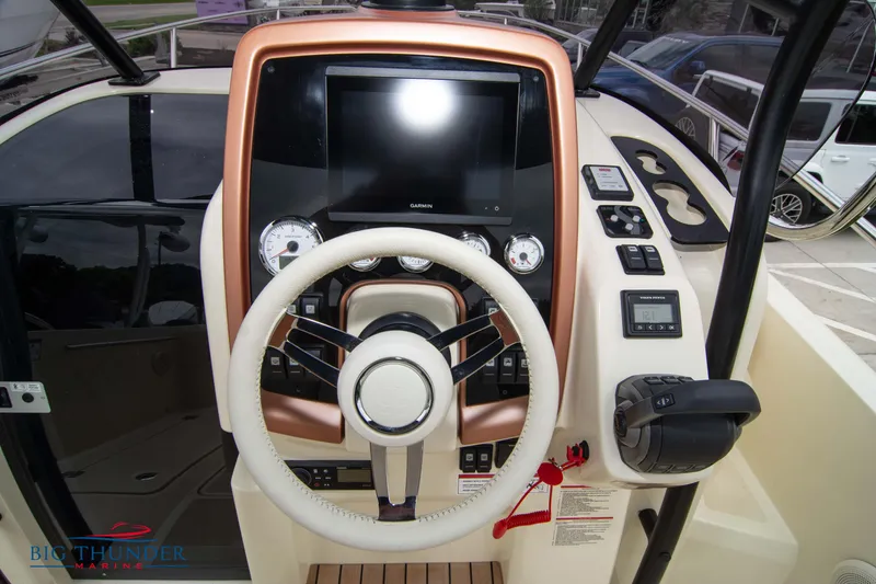Slide: The Image of 2024 Capoforte CX280i boat dashboard with steering wheel and control panel. - 24