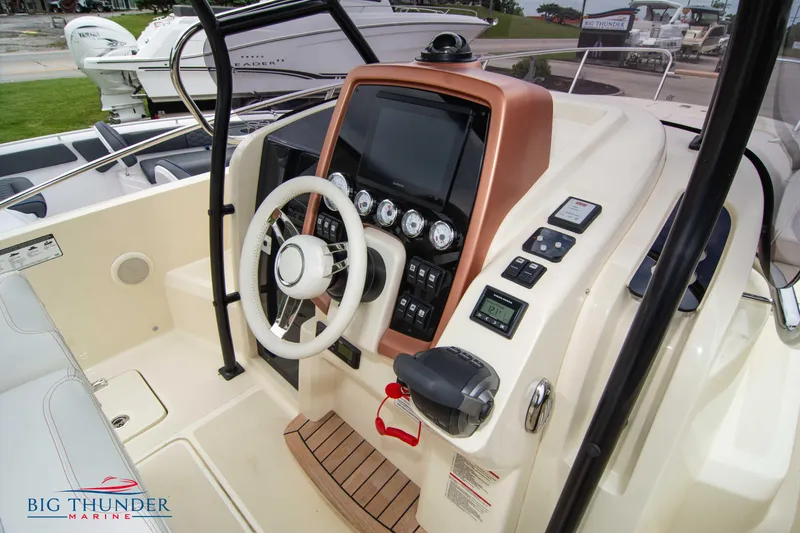 Slide: The Image of 2024 Capoforte CX280i boat dashboard with steering wheel and control panel. - 25