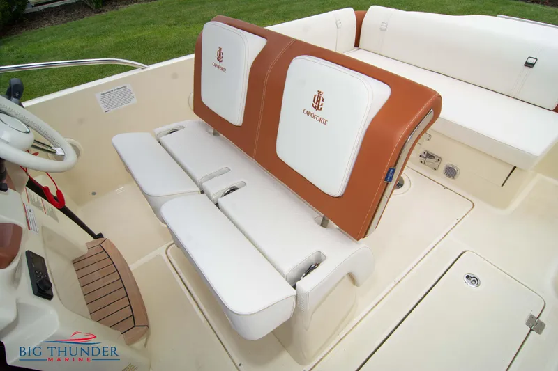 Slide: The Image of 2024 Capoforte CX280i boat interior with white and brown seating, Big Thunder Marine logo. - 42