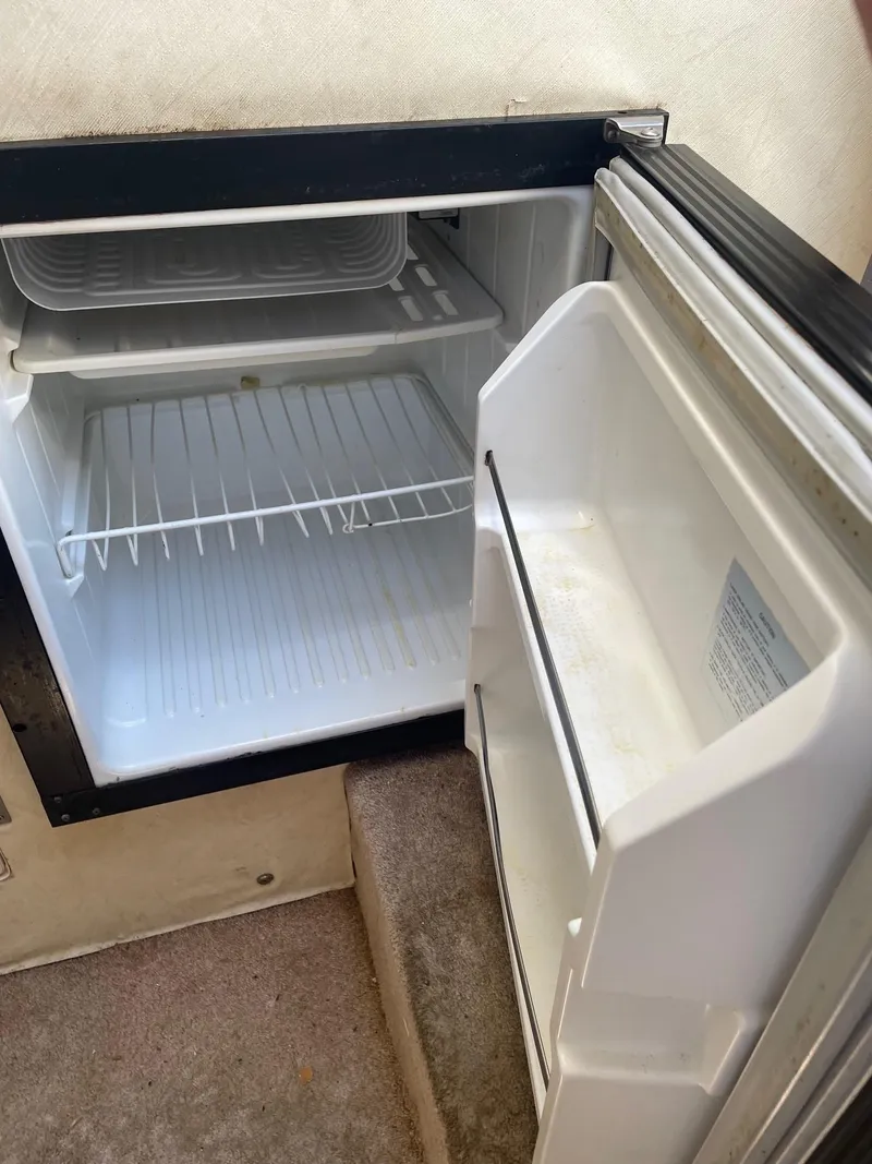 Slide: The Image of 1994 Bayliner 2655 Ciera boat refrigerator, open and empty. - 10