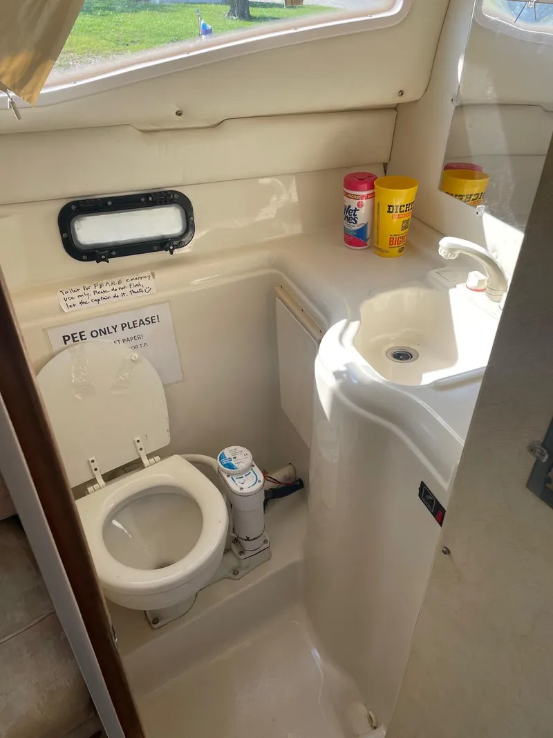 Slide: The Image of 1994 Bayliner 2655 Ciera boat bathroom with toilet, sink, and storage. - 12