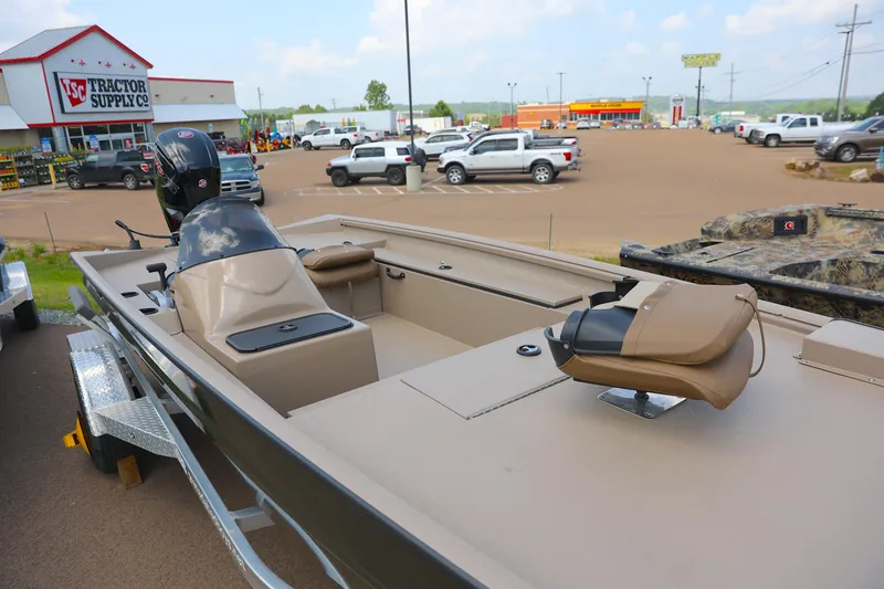 Slide: The Image of 2024 Excel 1860 Stalker SC boat displayed outside Tractor Supply Co. store. - 6