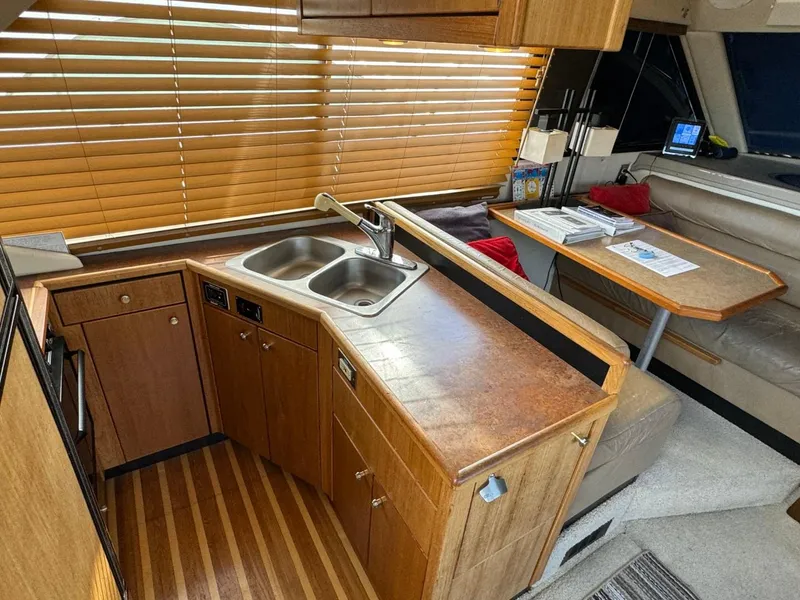 Slide: The Image of 1999 Bayliner 4087 Aft Cabin Motor Yacht interior with kitchen and dining area. - 11