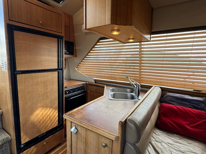 Slide: The Image of Interior of 1999 Bayliner 4087 Aft Cabin Motor Yacht with kitchen and seating area. - 12