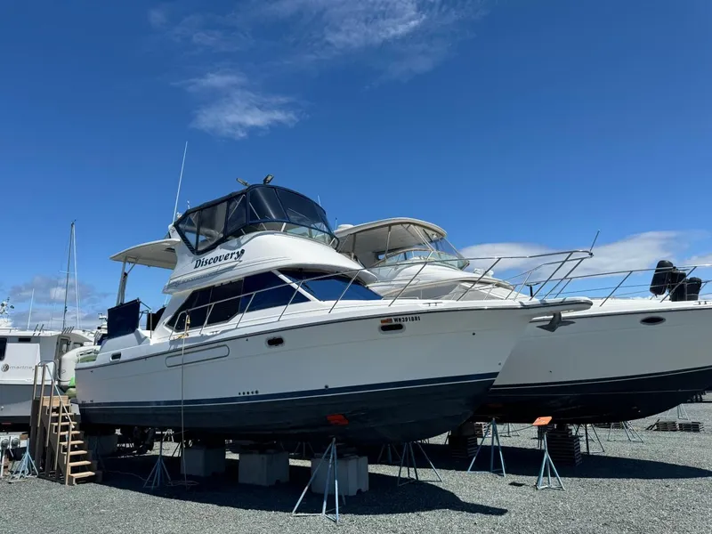The Image of 1999 Bayliner 4087 Aft Cabin Motor Yacht on display under clear blue sky. - 2