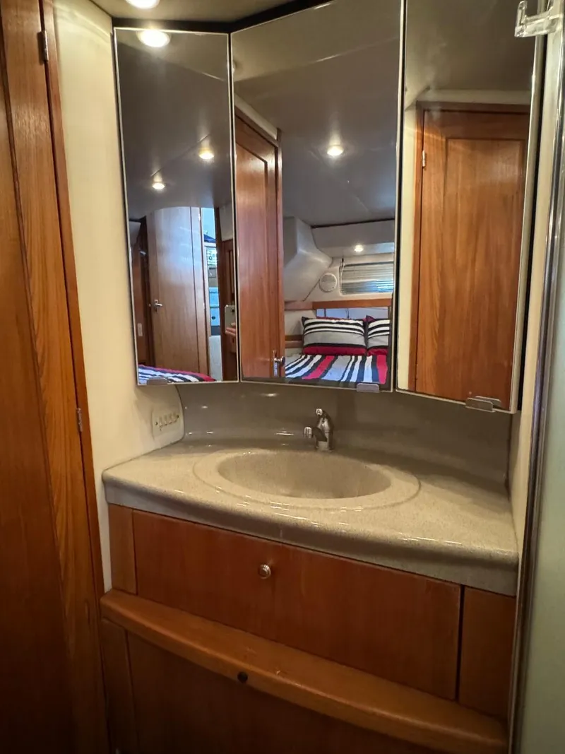Slide: The Image of 1999 Bayliner 4087 Aft Cabin Motor Yacht bathroom with sink and mirrored cabinet. - 28