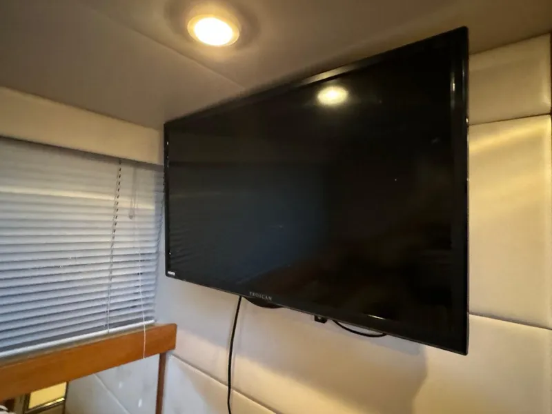 Slide: The Image of Wall-mounted TV in 1999 Bayliner 4087 Aft Cabin Motor Yacht interior. - 29