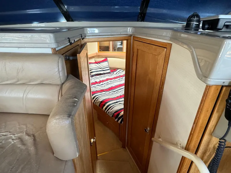 Slide: The Image of 1999 Bayliner 4087 Aft Cabin Motor Yacht interior with cozy cabin and striped bedding. - 30