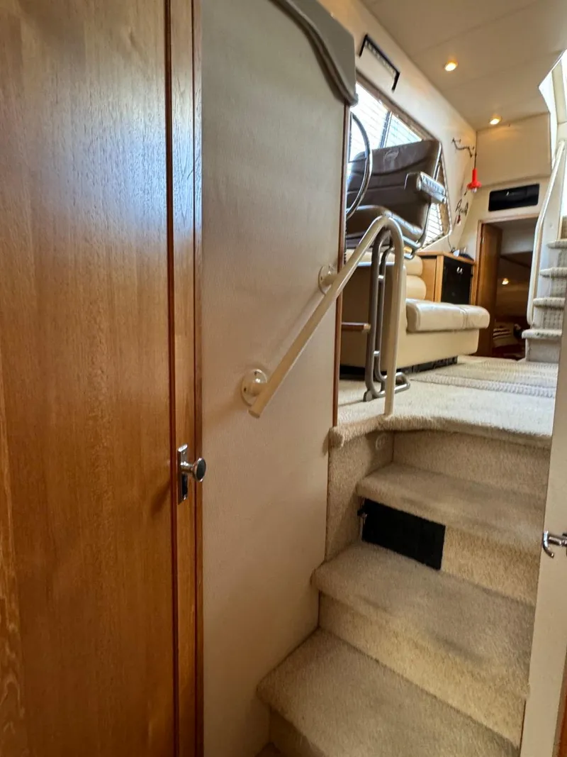 Slide: The Image of Interior view of 1999 Bayliner 4087 Aft Cabin Motor Yacht with carpeted stairs and seating area. - 34