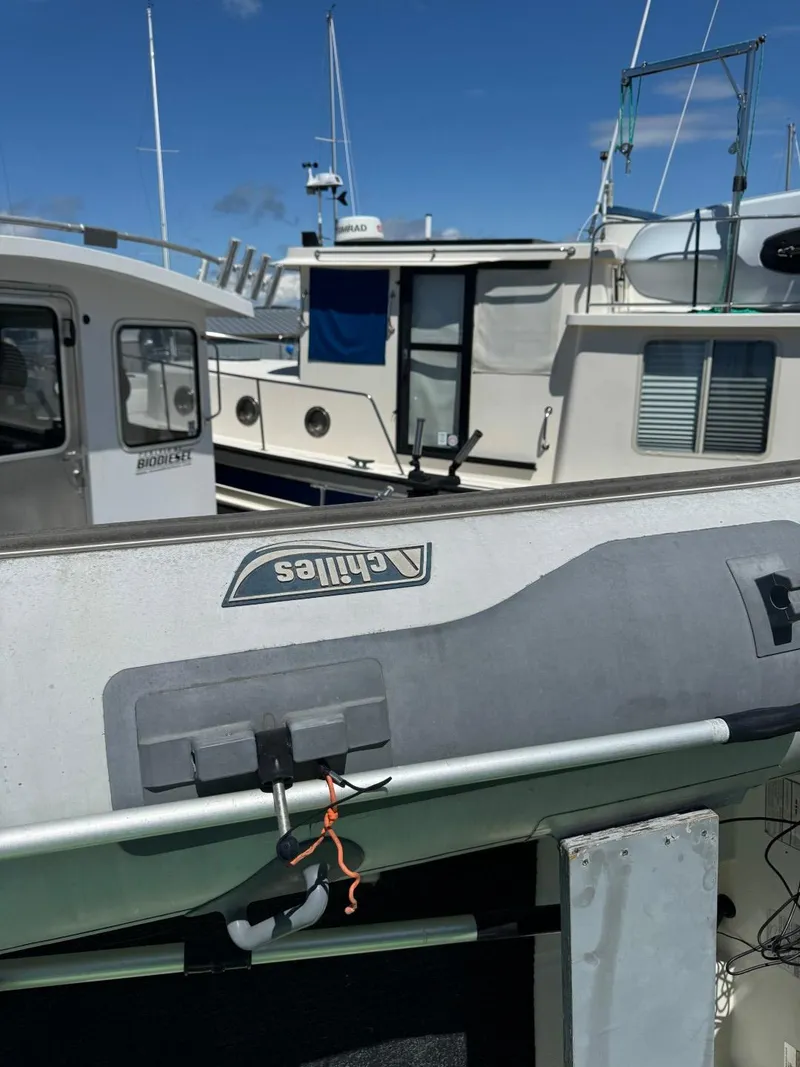 Slide: The Image of 1999 Bayliner 4087 Aft Cabin Motor Yacht docked with other boats under clear blue sky. - 41