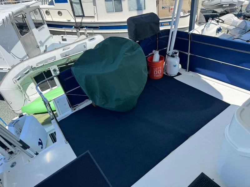 Slide: The Image of 1999 Bayliner 4087 Aft Cabin Motor Yacht deck with covered equipment and docked boats. - 9