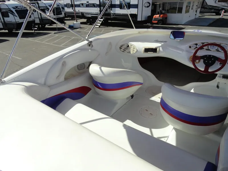 Slide: The Image of 1998 Baja Boss Hammer boat interior with white, red, and blue seating. - 11