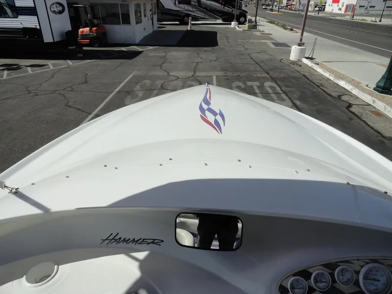 Slide: The Image of 1998 Baja Boss Hammer boat bow view in a parking lot. - 14