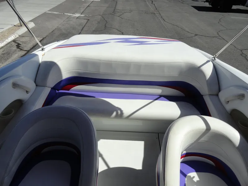 Slide: The Image of 1998 Baja Boss Hammer boat interior with white and purple seating. - 17