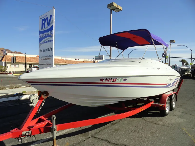 Slide: The Image of 1998 Baja Boss Hammer boat on red trailer with purple canopy. - 2