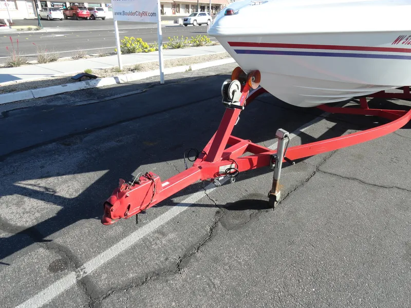 Slide: The Image of 1998 Baja Boss Hammer boat on red trailer in parking lot. - 20