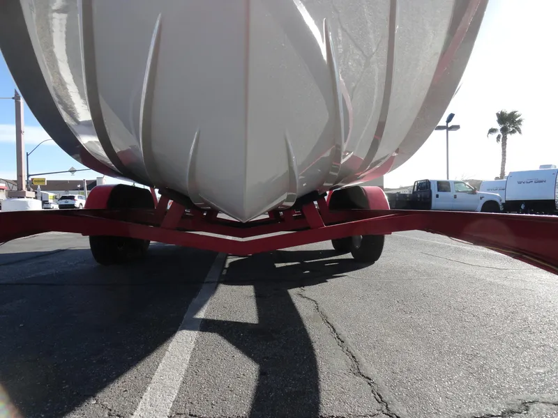 Slide: The Image of 1998 Baja Boss Hammer boat on a red trailer, viewed from below. - 21