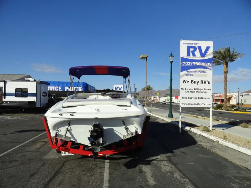 Slide: The Image of 1998 Baja Boss Hammer boat at RV dealership parking lot. - 22